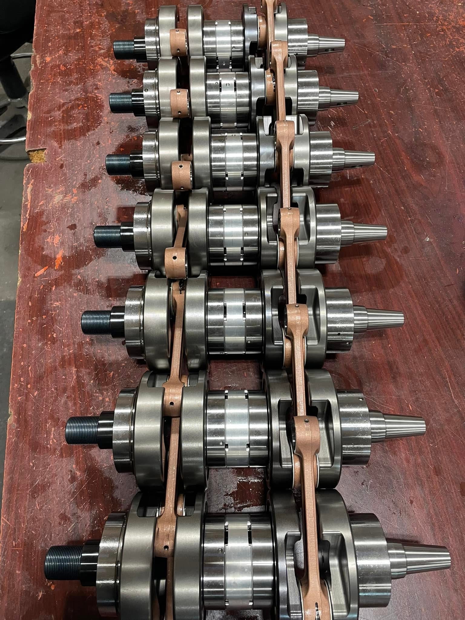 Row of rebuilt 2-stroke crankshafts on the bench